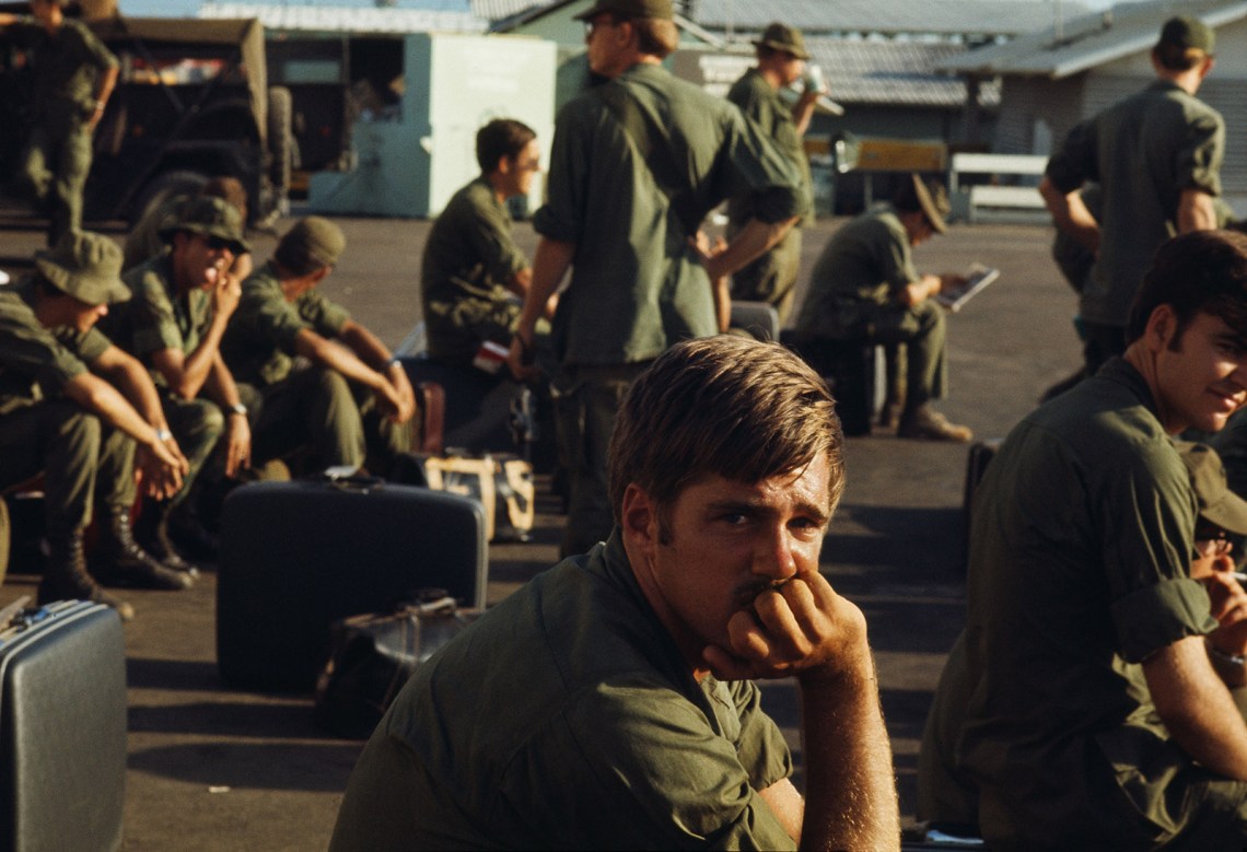 A group of soldiers waiting with luggage, South Vietnam, 1971