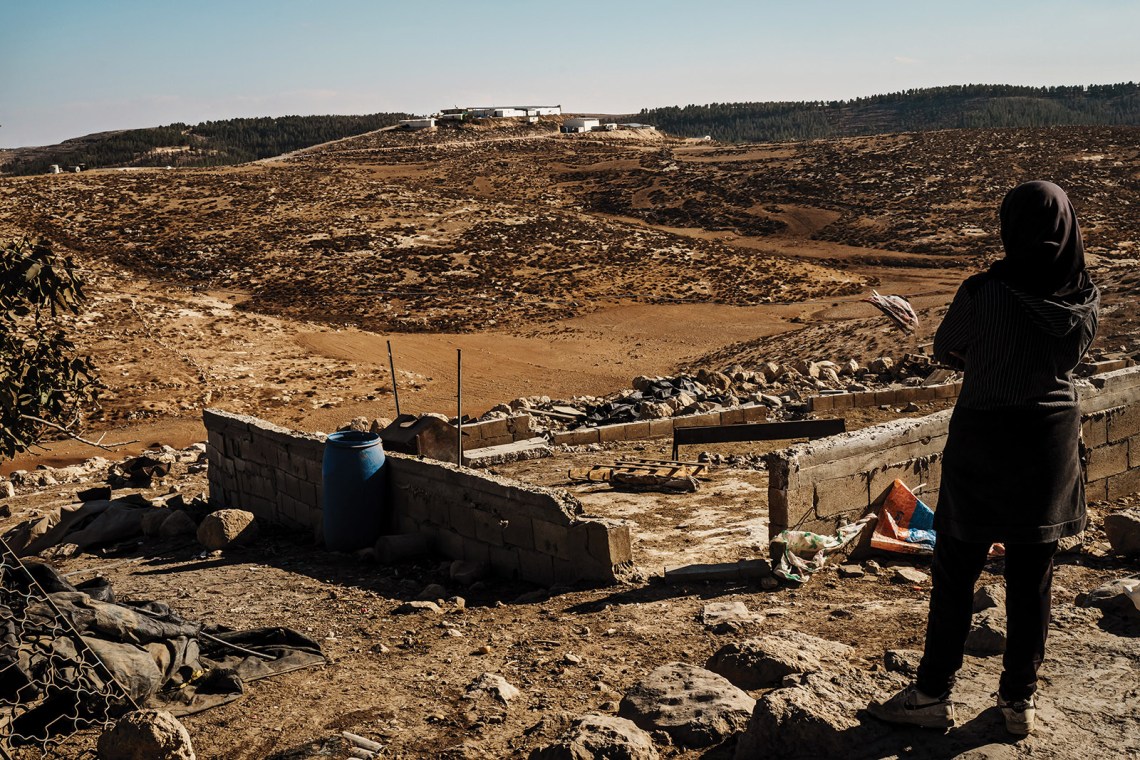 A Palestinian woman whose family is preparing to abandon their home in the West Bank village of Zanuta to escape violence by Israeli settlers